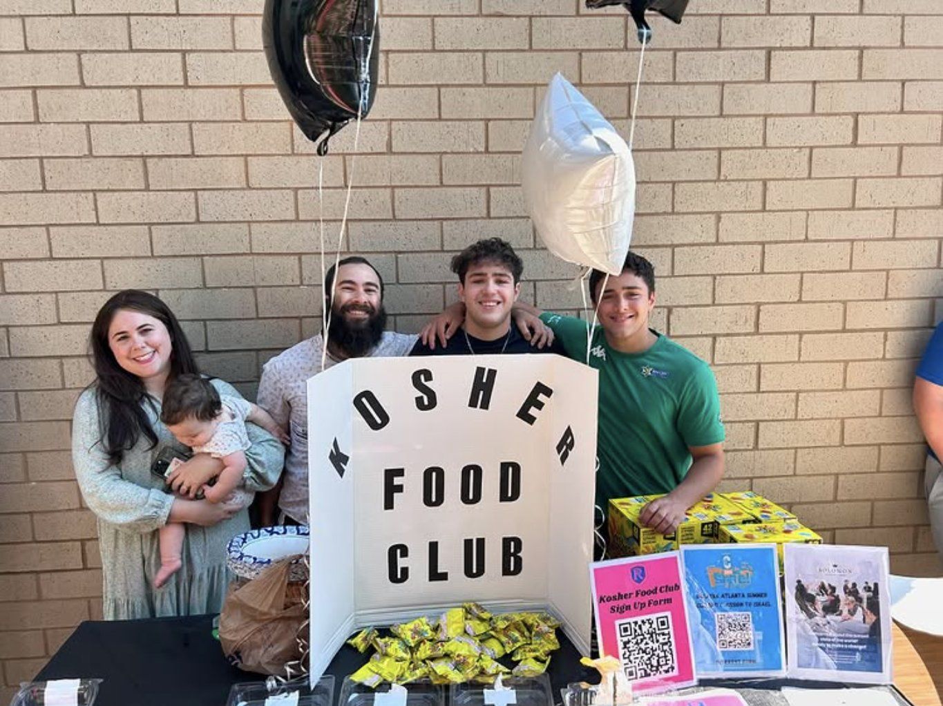Ari and Tal Elkounovitch with Rabbi David and Talia Goldschmidt at the Kosher Food Club table, 2024 Club Fair